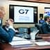 Joe Biden seated at a conference table during a G7 meeting with screens displaying participants. - Olive Oil Times