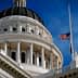 Close-up view of the California State Capitol building with a flag at half-mast. - Olive Oil Times