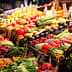 Colorful display of fresh fruits and vegetables arranged at a market stall. - Olive Oil Times