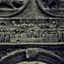 Detailed stone relief depicting historical figures and scenes in intricate carvings. - Olive Oil Times