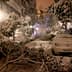A street covered in snow with fallen branches and parked cars partially obscured by snow. - Olive Oil Times