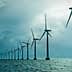 Row of offshore wind turbines standing in the ocean under a cloudy sky. - Olive Oil Times