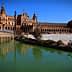 Plaza de España in Seville with a water canal and architectural structures in the background. - Olive Oil Times