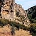 Rocky terrain featuring steep cliffs and scattered trees in a natural setting. - Olive Oil Times
