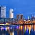 Night view of Buenos Aires cityscape with skyscrapers and waterfront reflections. - Olive Oil Times