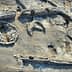 Aerial view of an archaeological site featuring various stone structures and formations. - Olive Oil Times