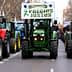 Line of tractors in a protest march displaying a banner that reads 'Precios Justos'. - Olive Oil Times
