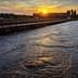 Water treatment facility with a view of the sunset reflecting on the water surface. - Olive Oil Times
