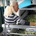 Woman with long blonde hair sorting green and black olives in a processing facility. - Olive Oil Times