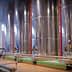 Row of stainless steel fermentation tanks used in winemaking process inside a winery. - Olive Oil Times