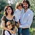 A family of four posing together in an olive grove, with two adults and two children. - Olive Oil Times