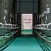 Interior view of a processing facility with stainless steel oil storage tanks and pipes. - Olive Oil Times