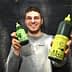 Person holding two bottles of Grazia extra virgin olive oil, one large and one small, both with green labels. - Olive Oil Times