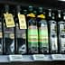 Various bottles of extra virgin olive oil displayed on a supermarket shelf. - Olive Oil Times