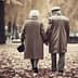 An elderly couple holding hands while walking through a park covered in autumn leaves. - Olive Oil Times