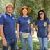 Five individuals wearing matching shirts standing together at an olive center. - Olive Oil Times