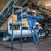 Industrial machinery used for processing olives in an olive oil production facility. - Olive Oil Times