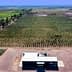Aerial view of an olive grove with a processing facility in the foreground. - Olive Oil Times