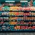 A grocery store aisle displaying various packaged food items on shelves. - Olive Oil Times