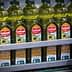 Rows of Carbonell olive oil bottles on a production line in a factory setting. - Olive Oil Times