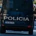 Rear view of a police van with the word 'Policia' on the back, driving on a city street. - Olive Oil Times