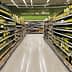 A supermarket aisle lined with shelves of olive oil bottles in various sizes and packaging. - Olive Oil Times