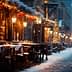 Outdoor dining area with tables and chairs on a snowy street during winter evening. - Olive Oil Times