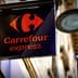 Sign for Carrefour Express featuring a red logo and the name in orange text on a black background. - Olive Oil Times