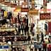 View of aisles at a food trade show with signage indicating aisle numbers and various booths. - Olive Oil Times