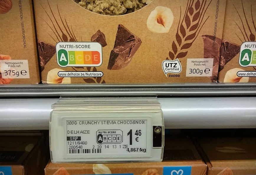 Nutri-Score label displayed on food packaging in a supermarket aisle. - Olive Oil Times