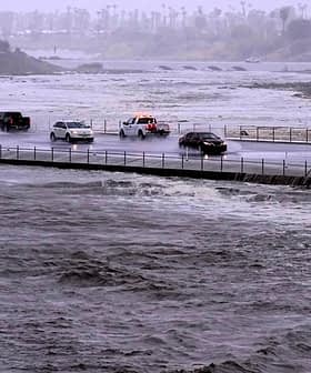 Vehicles cross over a flood control basin on Sunday, Aug. 20, 2023, in Palm Desert, Calif.