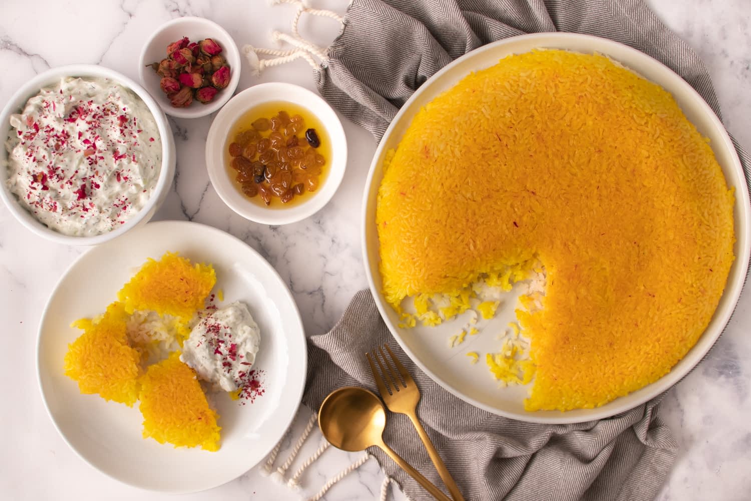 Ein rundes Safranreisdessert mit herausgenommener Portion, serviert mit ...