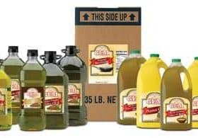 Various bottles of olive oil in different sizes alongside a cardboard box labeled with product information. - Olive Oil Times