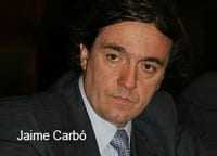 Close-up portrait of Jaime Carbo, a man with dark hair and a serious expression wearing a suit. - Olive Oil Times