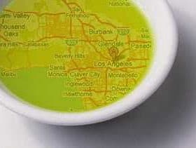 Map of Los Angeles displayed in a small white dish filled with olive oil. - Olive Oil Times