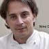 Portrait of chef Nino Di Costanzo wearing a white chef's coat and looking directly at the camera. - Olive Oil Times