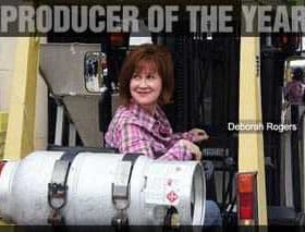 Deborah Rogers sitting on a forklift, labeled '2010 Producer of the Year'. - Olive Oil Times