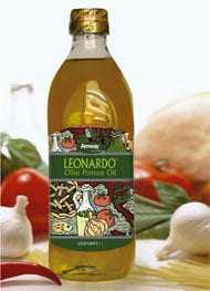 Bottle of Leonardo olive oil with a decorative label featuring vegetables and herbs. - Olive Oil Times