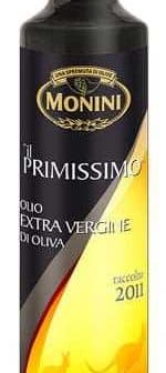 Bottle of Monini Il Primissimo extra virgin olive oil with a black and gold label. - Olive Oil Times