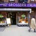 Storefront of Grosseria Italiana with a sign and display of flowers and produce. - Olive Oil Times