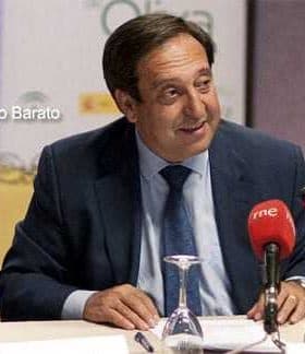 A man named Pedro Barato speaking at a conference with microphones in front of him. - Olive Oil Times