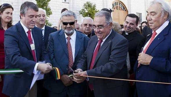 Group of officials participating in a ribbon cutting ceremony with scissors and ribbon. - Olive Oil Times