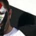 Man with Syrian flag face paint and holding a Syrian flag during a demonstration. - Olive Oil Times