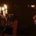 A child gazing at a menorah with lit candles during a celebration. - Olive Oil Times