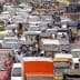 A congested urban road filled with various vehicles in a traffic jam. - Olive Oil Times