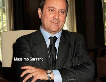 Portrait of Massimo Gargano with arms crossed, wearing a suit and tie. - Olive Oil Times