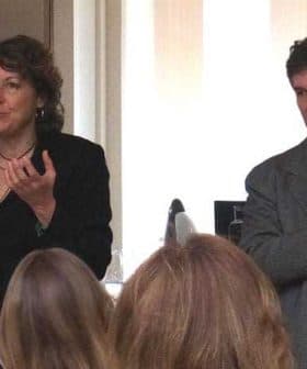 Two presenters speaking during a cooking demonstration in a kitchen setting. - Olive Oil Times