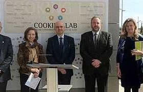 A group of six individuals standing in front of a Cooking Lab sign during an event. - Olive Oil Times