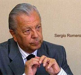 Sergio Romero Pizarro seated and looking thoughtfully with hands clasped together. - Olive Oil Times