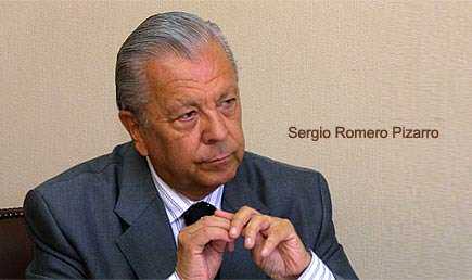 Sergio Romero Pizarro seated and looking thoughtfully with hands clasped together. - Olive Oil Times